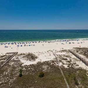 Enjoy the vibrant beach scene with colorful umbrellas and inviting waters, perfect for a day of relaxation