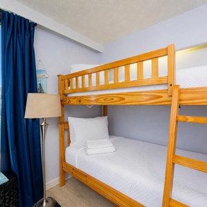 Bright bunk area invites your family to relax on soft beds after a day on the beach