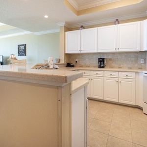 Prepare delicious meals while enjoying the cozy vibe of your beach retreat in this inviting kitchen space