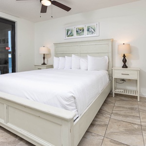 Unwind in the spacious master bedroom featuring a comfortable king bed, soft linens, and beach balcony access