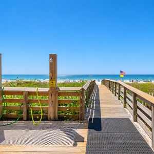 Step onto the boardwalk leading to the beach, complete with an outdoor shower for rinsing off after a fun day by the water