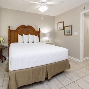 Cozy queen bed in the guest suite invites you to sink in and drift off after beach days together