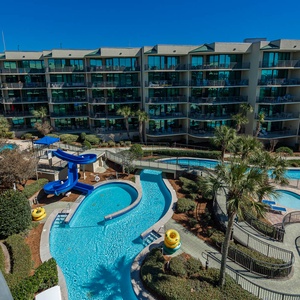 Discover the refreshing pool area with an inviting lazy river and thrilling waterslide