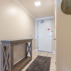 Welcoming entryway featuring a stylish console table and soft lighting, setting an inviting tone for your beach vacation