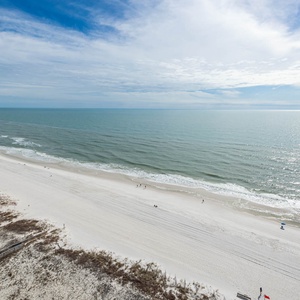 Gaze at the tranquil waters and shoreline while enjoying the refreshing breeze from your balcony retreat