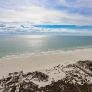 Gaze at the serene waters and expansive shoreline, perfect for relaxation and beach activities