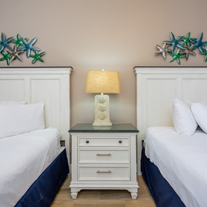 Relax on one of the cozy queen beds in this guest suite and enjoy a peaceful slumber