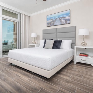 Retreat to the king master suite with cozy bedding and drift off to the sound of the waves from the balcony