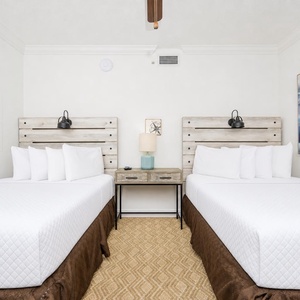Rest in this charming guest room with two double beds, stylish decor, and a bedside table for your convenience