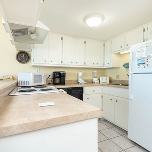 This kitchen features essential appliances and ample counter space, perfect for preparing meals during your stay