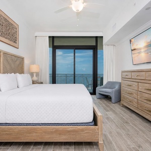 Relax in this master suite featuring a king bed, stylish decor, and beachfront balcony access