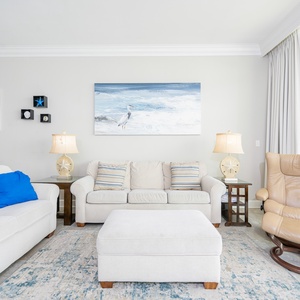 Stretch out on the plush sofa with a queen sleeper, enjoying the soft textures and coastal decor