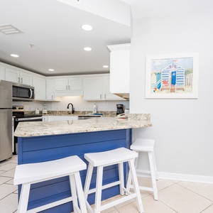 Gather around the sleek granite counter with seating, perfect for casual meals and morning coffee