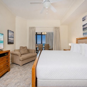 Relax in this inviting master bedroom featuring a plush king bed, cozy twin sleeping chair, and a stunning view