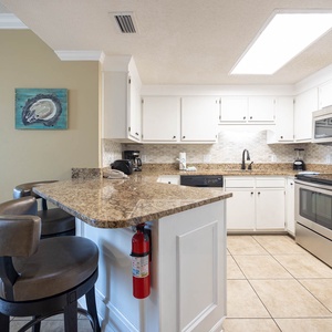 Prepare meals at the granite counter, enjoying the bright kitchen with stainless appliances and a welcoming vibe