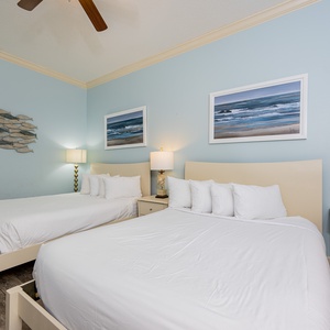 Rest in the cozy queen beds in this guest suite, enjoying the soothing beach decor during your stay
