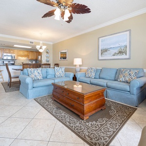 Unwind in the spacious living area, with a sofa with queen sleeper, coffee table, and a view of the dining space beyond