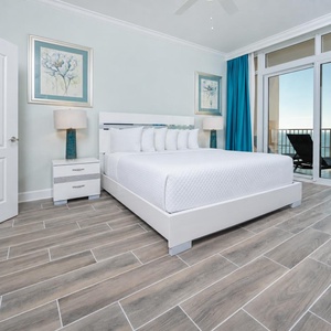 Retreat to the king master suite with cozy bedding and drift off to the sound of the waves from the balcony