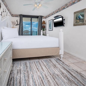 Unwind in the master bedroom featuring a plush king bed, stylish decor, and a view that invites relaxation