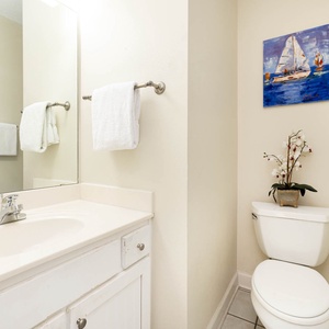 Refresh in this guest bathroom featuring a spacious vanity, ample towels, and a lovely decorative touch