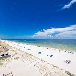 Take in the expansive views from the balcony, overlooking the beach and vibrant waters below, perfect for relaxation