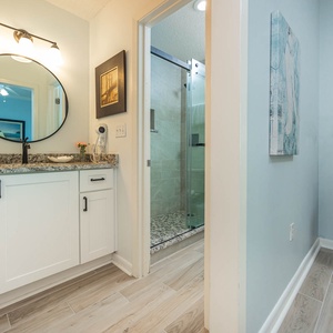 Experience this stylish master bath featuring a granite countertop, modern fixtures, and a spacious walk-in shower