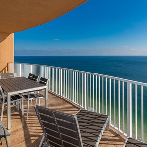 Savor meals or relax on the spacious balcony, enjoying expansive views of the tranquil coastline