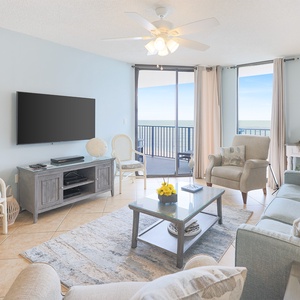 Relax in this inviting living area, featuring a sofa with queen sleeper, large TV, and beachfront views