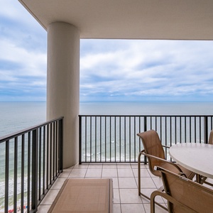 Impressive views from the spacious balcony, complete with comfortable seating and a dining table for outdoor meals