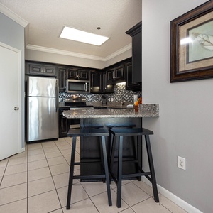 Gather around the granite breakfast bar, perfect for casual meals and morning coffee in the kitchen