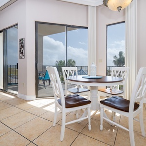 Dine at the round table while enjoying views through the sliding glass doors that open to the balcony