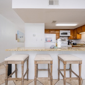 Gather around the inviting counter stools and enjoy a casual morning coffee while soaking in the coastal vibe