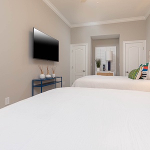 Unwind in this queen guest suite with stylish accents and stream your favorite shows or enjoy a good movie after a beach day