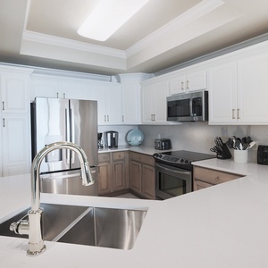 Gather in this stylish kitchen featuring stainless appliances, spacious countertops, and elegant design