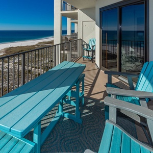 The balcony offers a perfect spot to enjoy the serene gulf view and white sand beach below