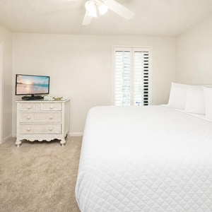 Enjoy a restful slumber in this soft, inviting king bed, with gentle light streaming through the window of the guest room
