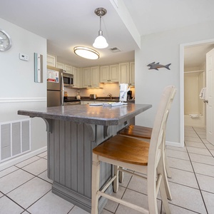 This kitchen features light cabinetry, stainless appliances, and a breakfast bar, perfect for casual dining and entertaining