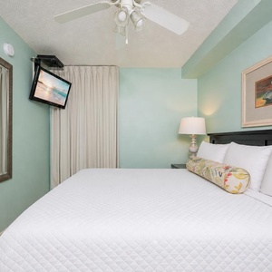 Fluffy pillows invite you to relax in the king suite for a calm movie night after a fun day at the beach