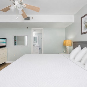 Gentle lamp light creates a cozy spot to unwind in your king suite after a day on the beach