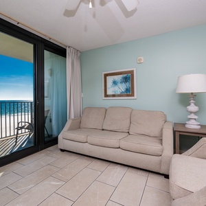 Unwind on the comfortable sofa with queen sleeper while enjoying the beautiful view from your beachfront balcony