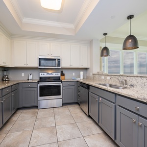 Craft delightful meals in the kitchen with stylish cabinetry and stainless appliances promoting culinary creativity