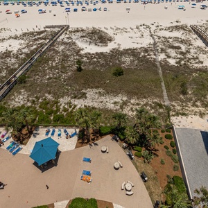 Relax by the poolside, enjoying the sun and vibrant atmosphere with easy access to the beach just steps away