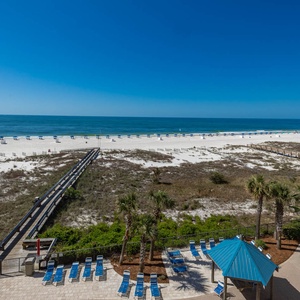 Bask in the sun by the poolside, with easy access to the beach and inviting lounge chairs for relaxation