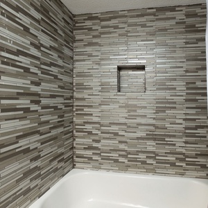 Tiled tub shower combination in the guest bathroom