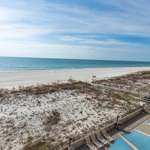 Enjoy the serene view of the water and beach from your balcony, perfect for relaxation and unwinding