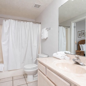 Refresh in the guest bathroom, featuring a spacious vanity, ample towels, and a tub-shower combo