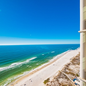 This stunning view showcases a beach balcony with inviting seating, perfect for relaxing and enjoying the coastal scenery