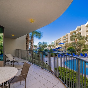 Unwind on the balcony, soaking in the coastal breeze and views of the lush pool area below