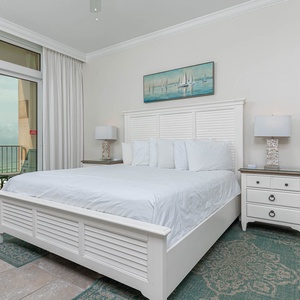 Relax in the master bedroom, where the cozy king bed invites restful nights and the coast whispers from the balcony
