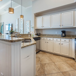 This kitchen features granite countertops, stainless appliances, and a cozy breakfast bar, perfect for preparing family meals
